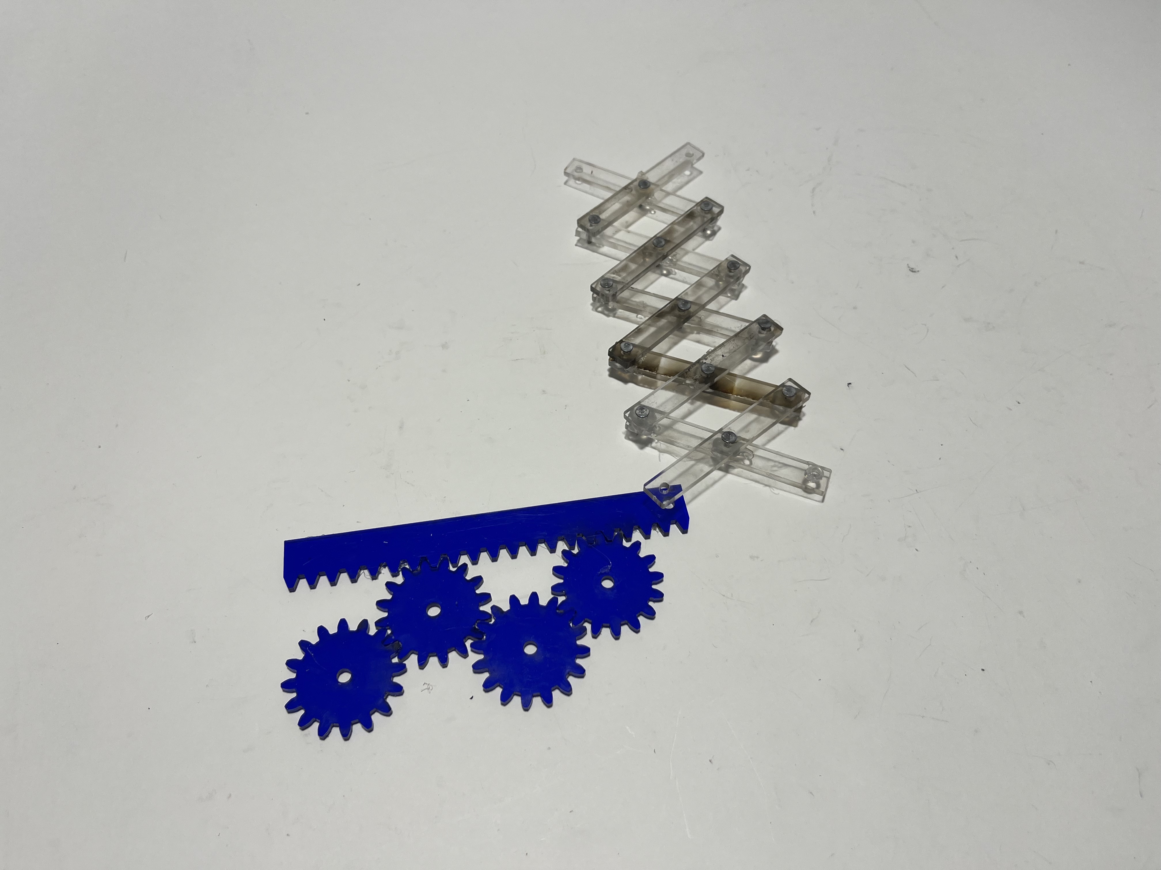 Scissor linkage with rack and pinion